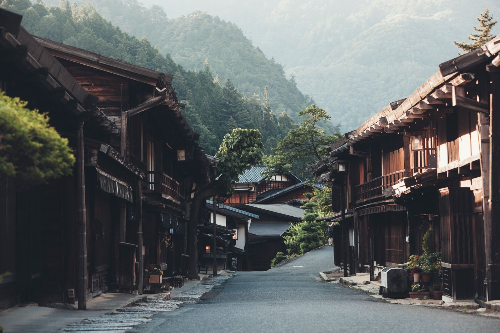 On a sunny day on the Nakasendo trail the pathway connecting Kyoto and Tokyo in Japan a travelling man is hiking with a...