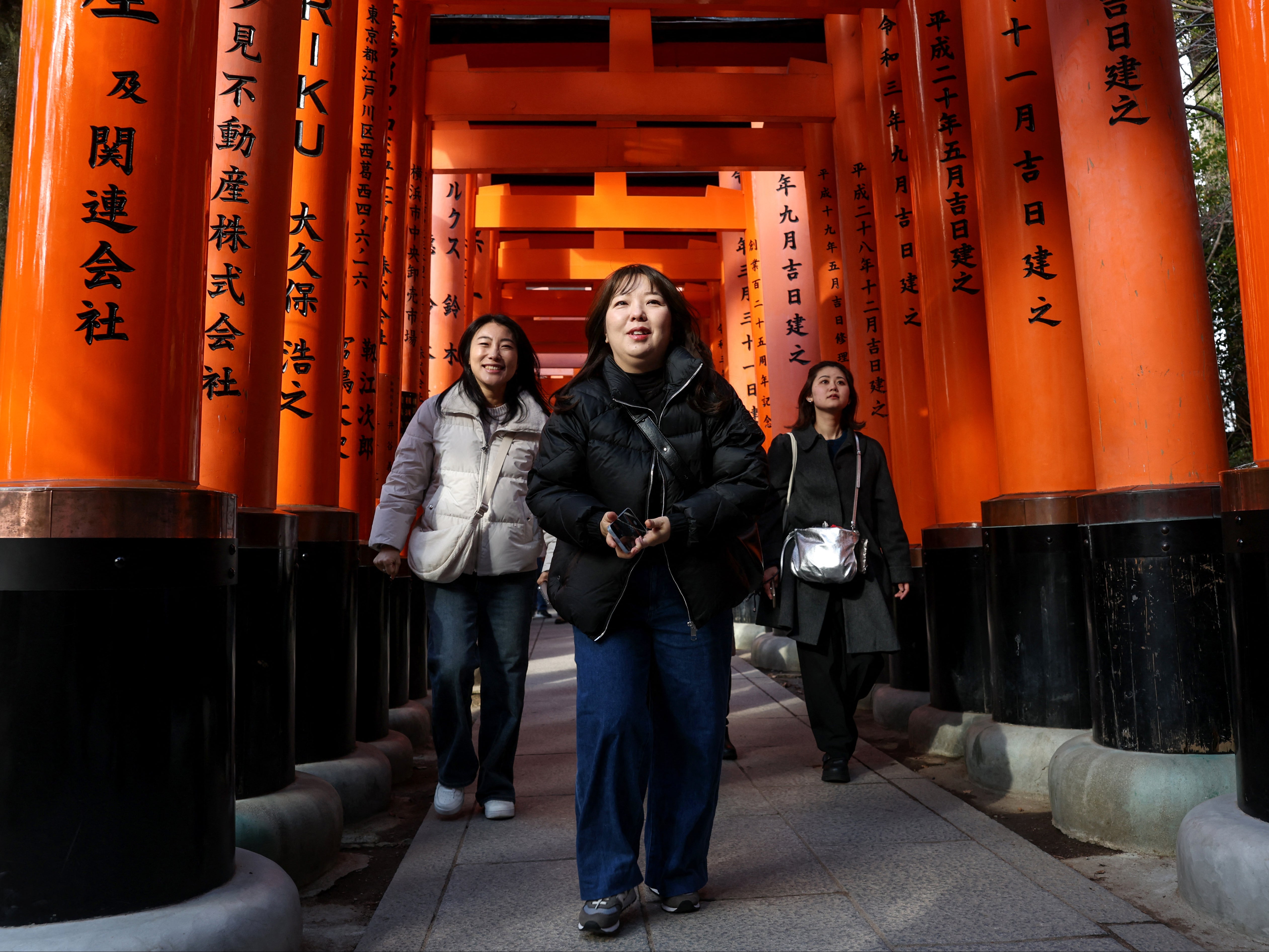 Tourists visit Fushimi Inari Shrine in the city of Kyoto on January 13, 2025
