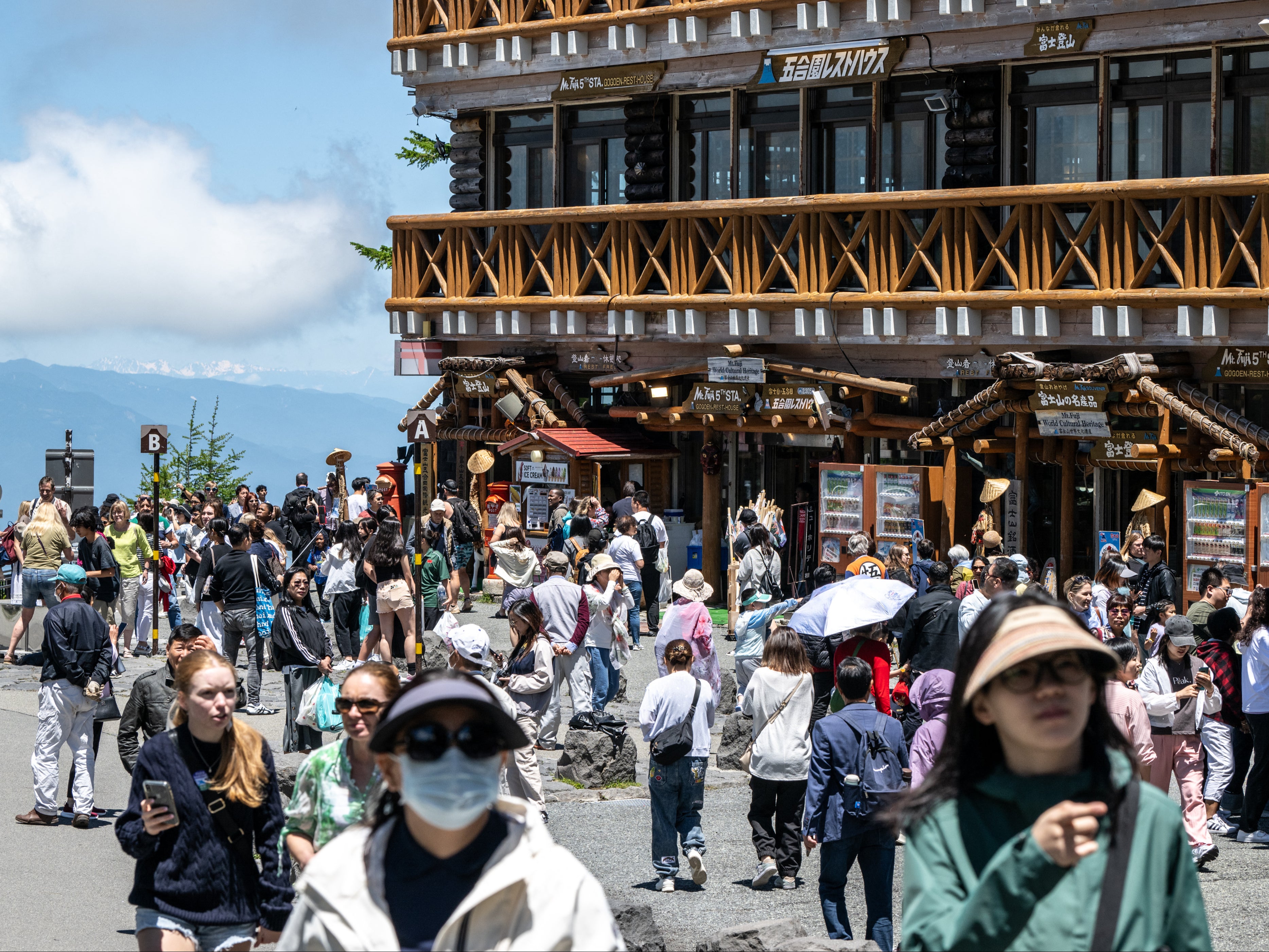 Tourists outside the Fuji Subaru Line 5th station, which leads to the popular Yoshida trail for hikers climbing Mount Fuji