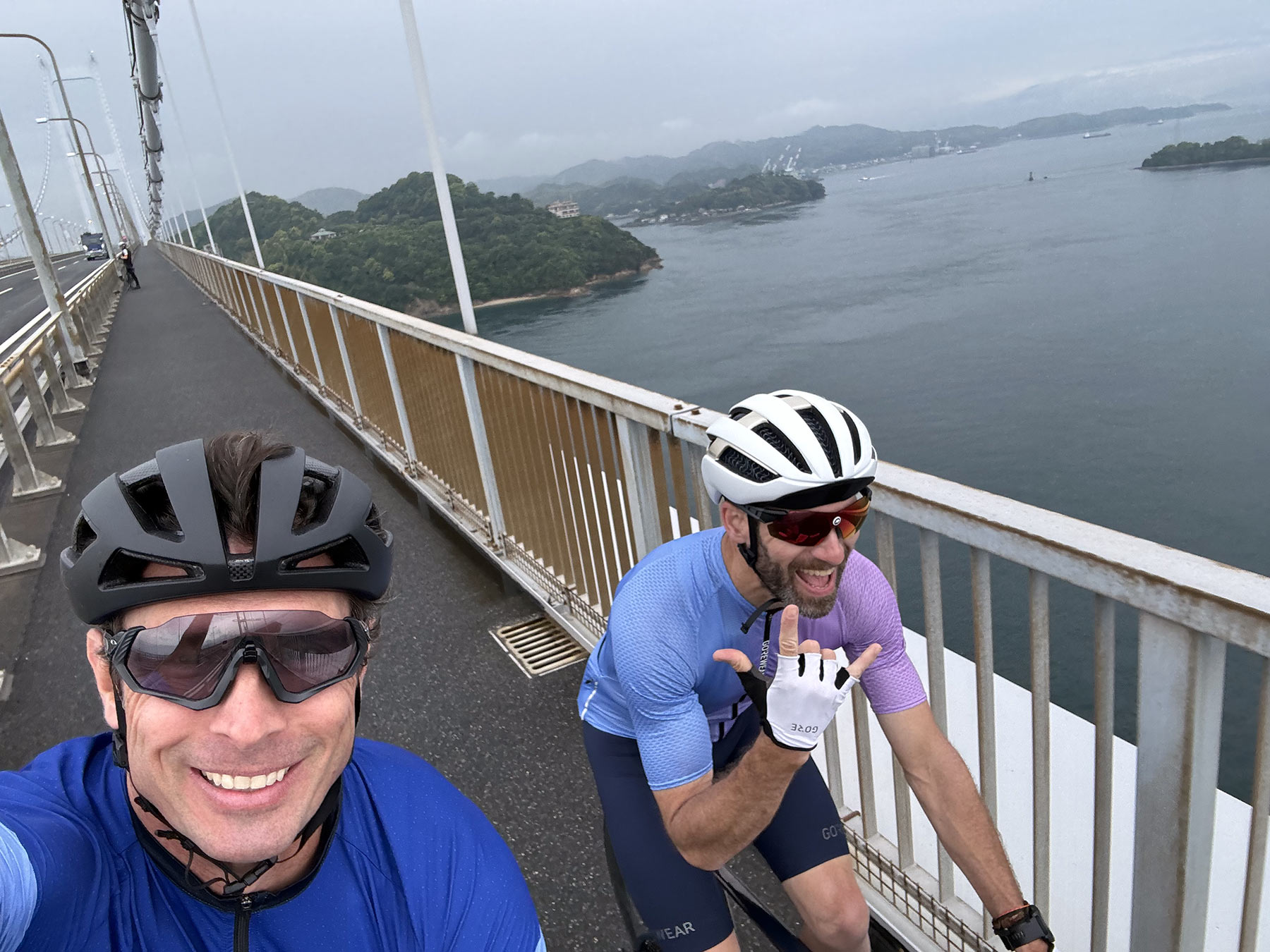tyler and steve riding on bridge in shikoku island japan.