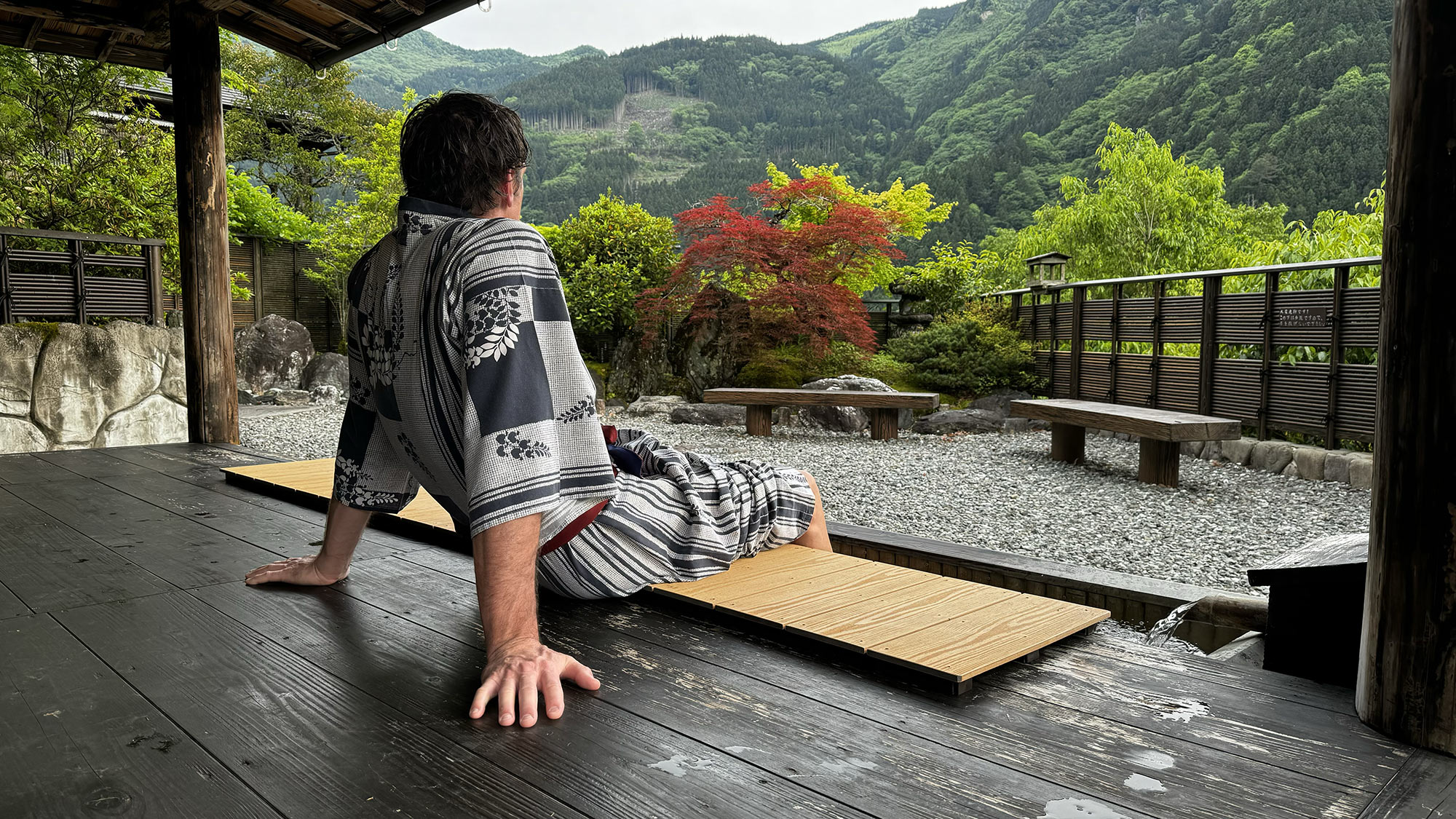 tyler sitting outside onsen in japan.