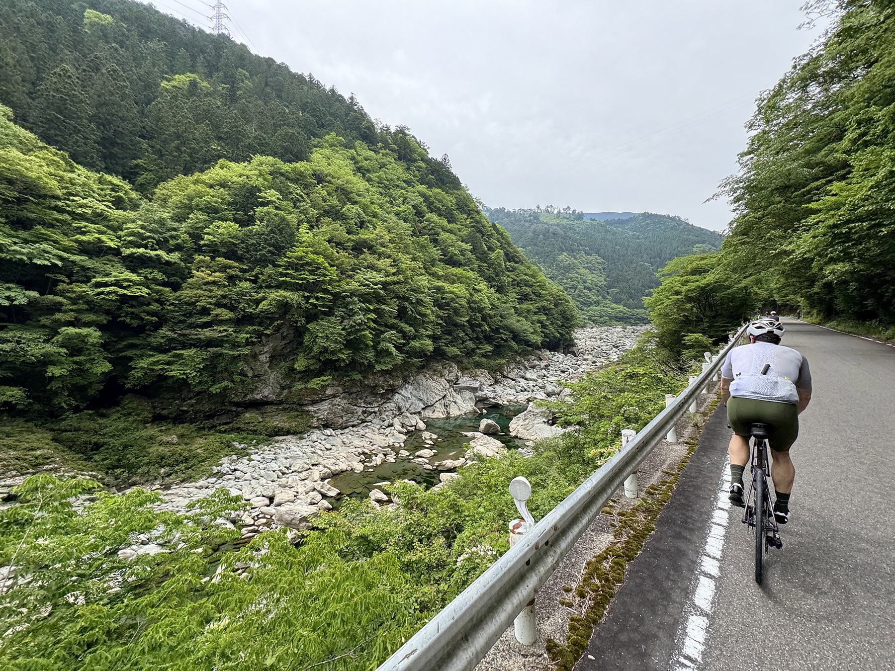 cycling next to a river with ride and seek tour group on shikoku island japan.