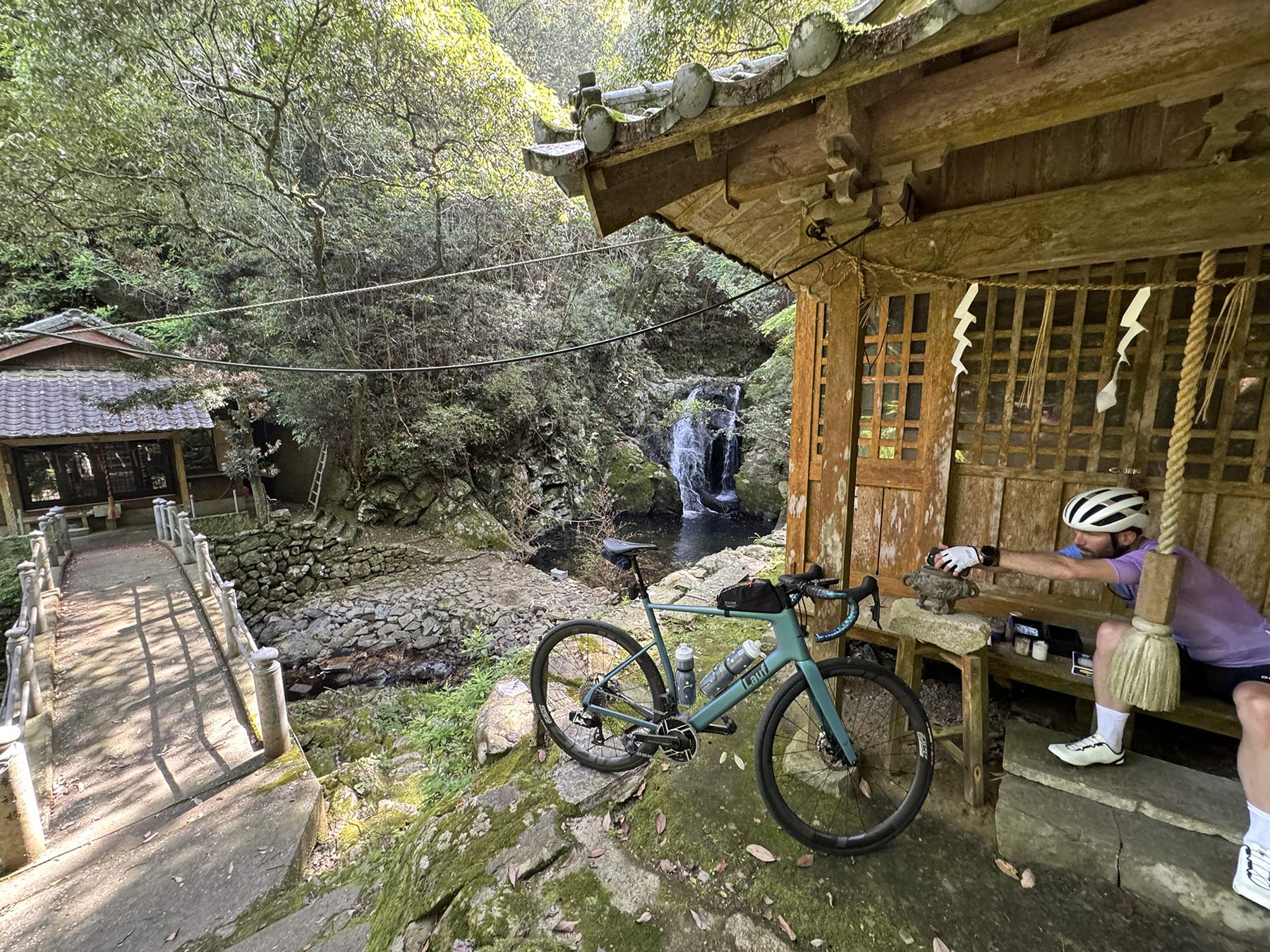 mountain temple next to a waterfall in japan.
