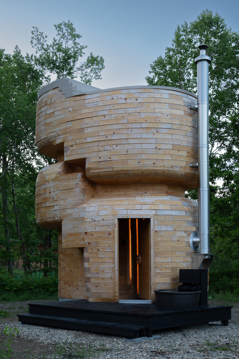 VUILD stacks curving prefabricated wood blocks to shape tower sauna in hokkaido