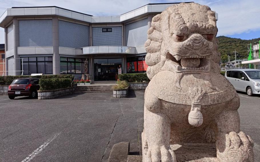 a guardian dog is situated in front of the museum.