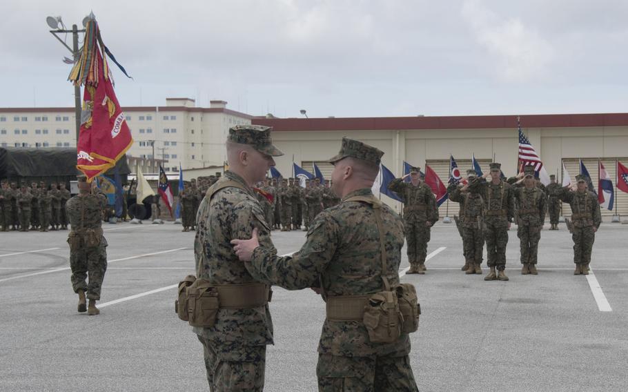 Col. Peter Eltringham, right, congratulates Lt. Col. Jacob Godby on assuming command at a ceremony.