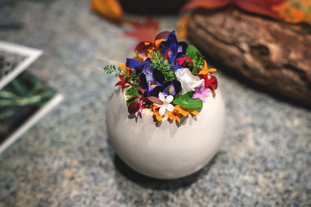 A dish covered in edible flowers at Chef's Table  by Katsuhito Inoue, in The Ritz-Carlton, Kyoto