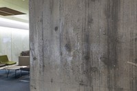 An exposed concrete column is seen at the 
