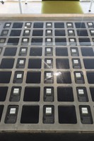 Key boxes embedded in the top of a table are seen beside the entrance of the 