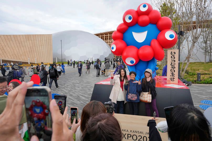 Visitors take photos on the opening day of Osaka Expo 2025 in Osaka, western Japan, Sunday, April 13, 2025