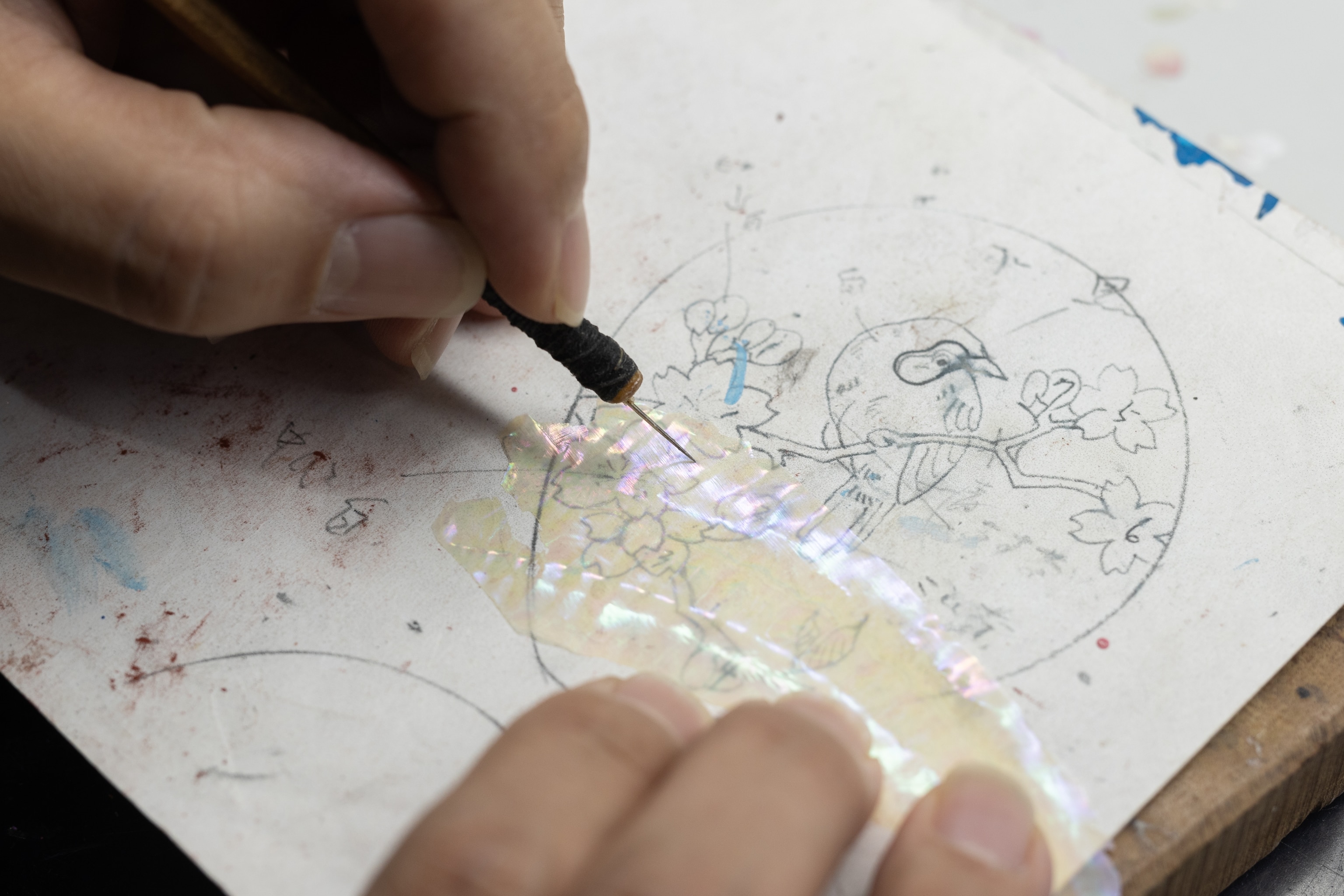 Toyama artisan Takeshi Musashigawa carefully cutting mother of pearl to create the intricate designs of Takaoka shikki lacquerware.