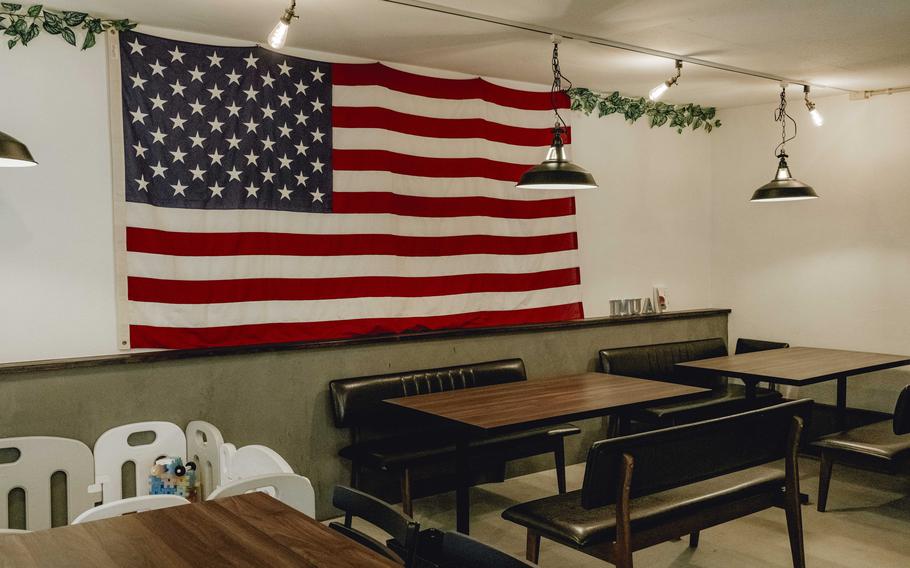 the interior of the restaurant. an american flag can be seen.