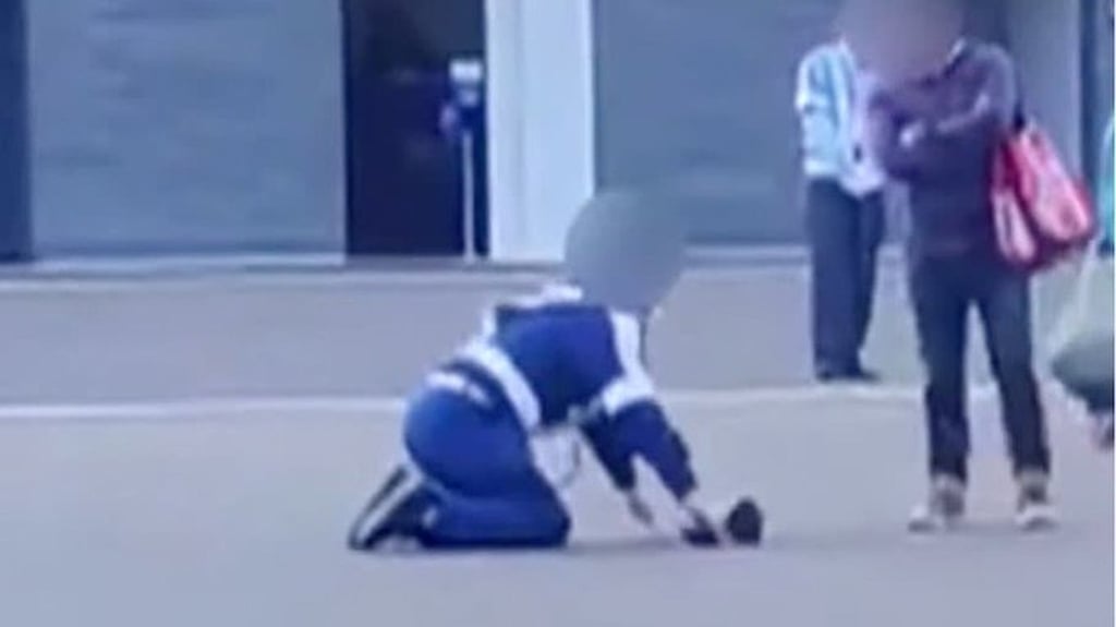 A viral online video shows the security guard on his knees in front of the tourist. Photo: Handout