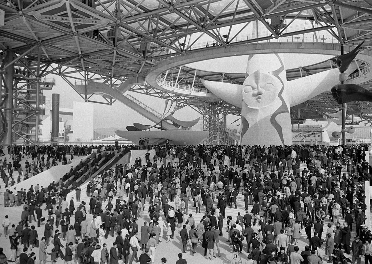 The iconic Tower of the Sun stands over the crowded Expo venue in the Senri hills of Osaka Prefecture. (© Jiji)