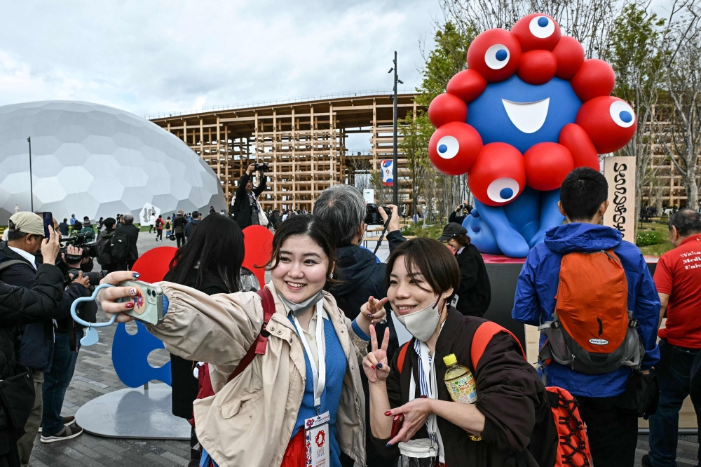 People pose for a photo in front of 