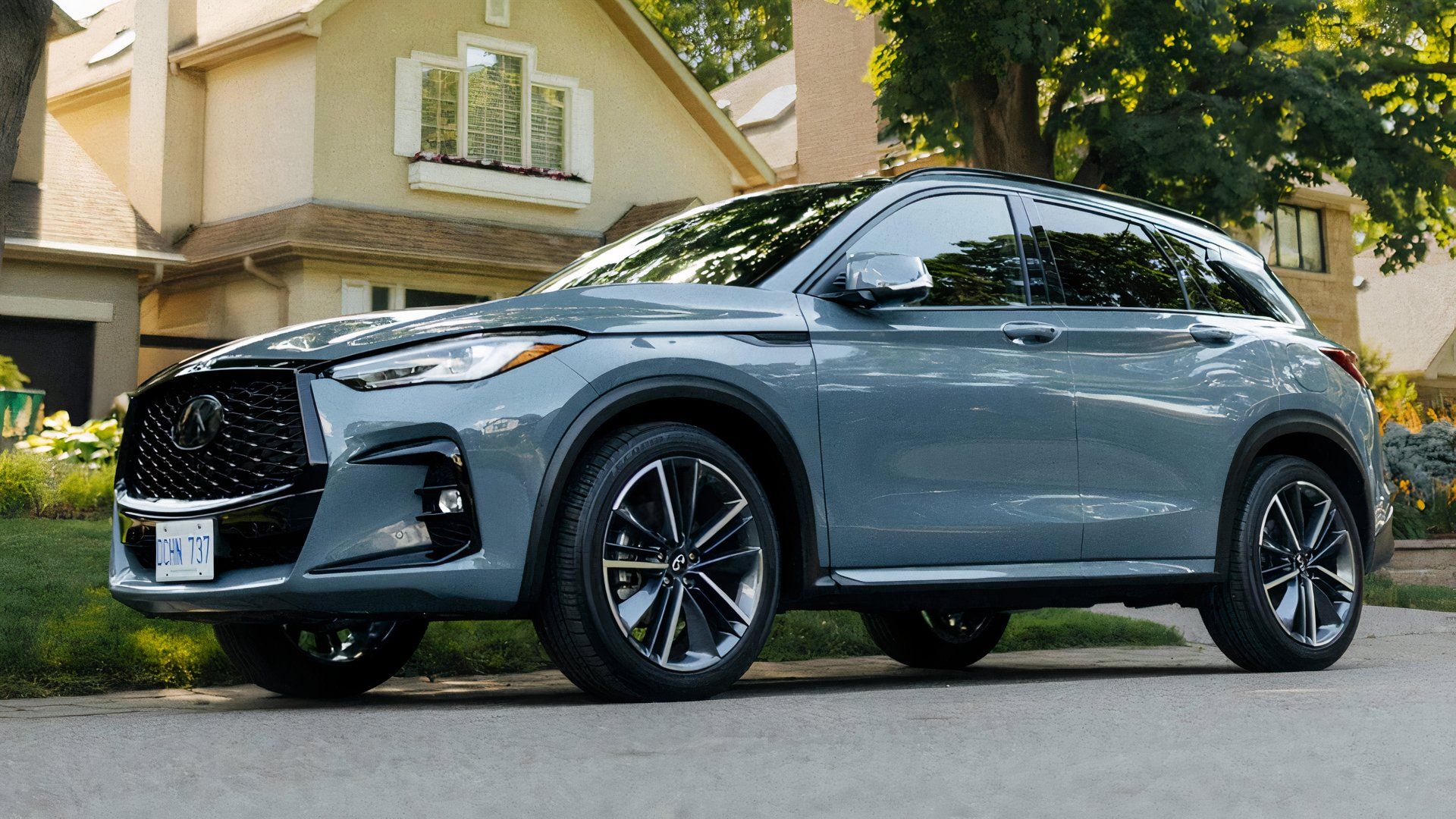 2025 Infiniti QX50 in blue parked in front of home
