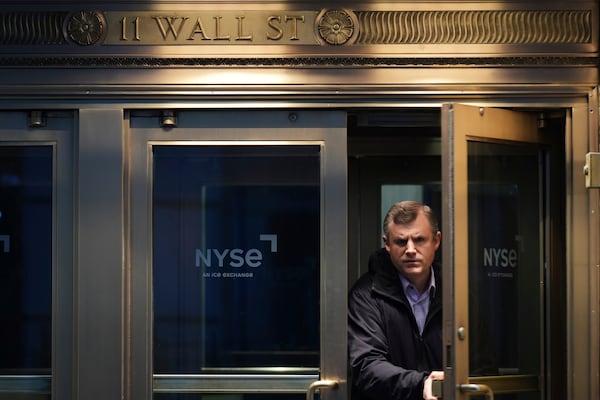 People leave the New York Stock Exchange after the closing bell in New York, Monday, April 7, 2025. (AP Photo/Seth Wenig)