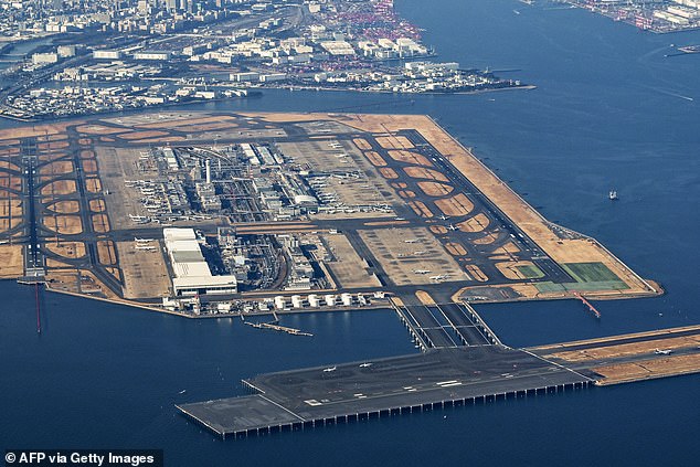 Instead of landing at Tokyo's Haneda Airport (pictured) the plane flew an addition five hours and landed at Dallas Fort Worth International Airport