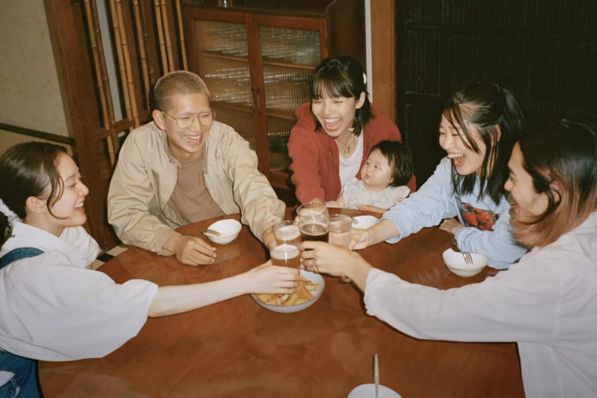 Airbnb Bets Big on Domestic Travel in Japan with New Marketing Push A Japanese family sitting around a table and laughing.