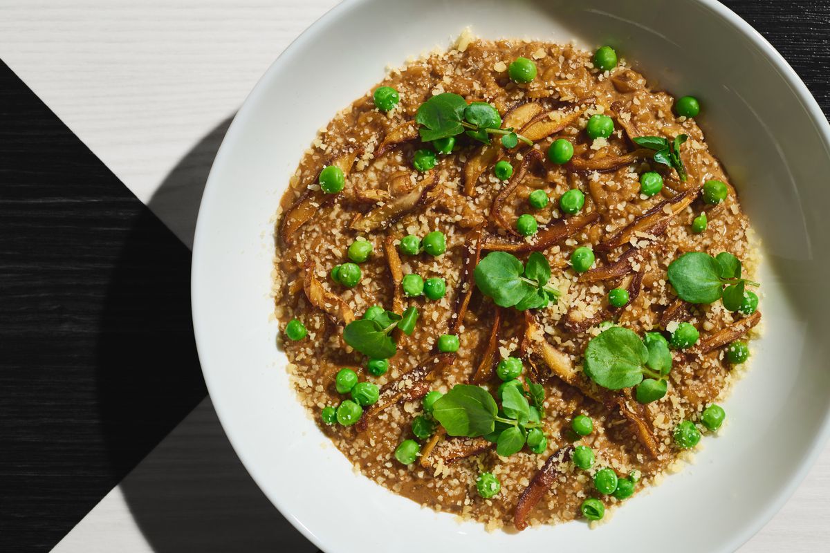 A shallow bowl of rice and greens.