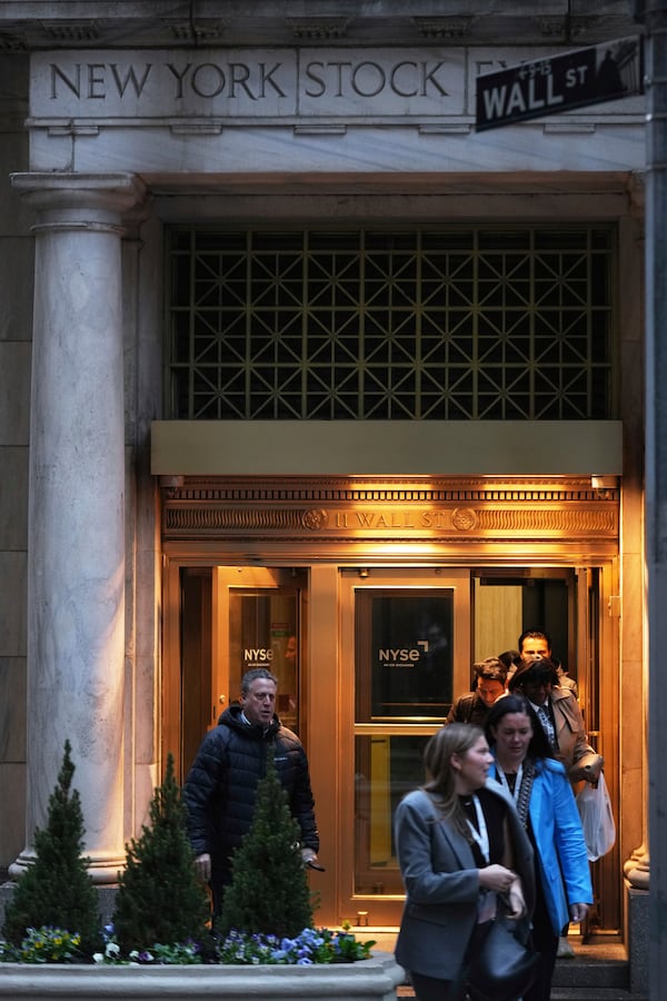 People leave the New York Stock Exchange after the closing bell in New York, Monday, April 7, 2025. (AP Photo/Seth Wenig)
