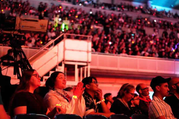 Fans react to the opening act during the Star Wars...
