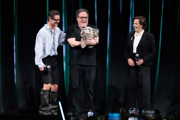 Actor Pedro Pascal, left, and Sigourney Weaver, right, with director...