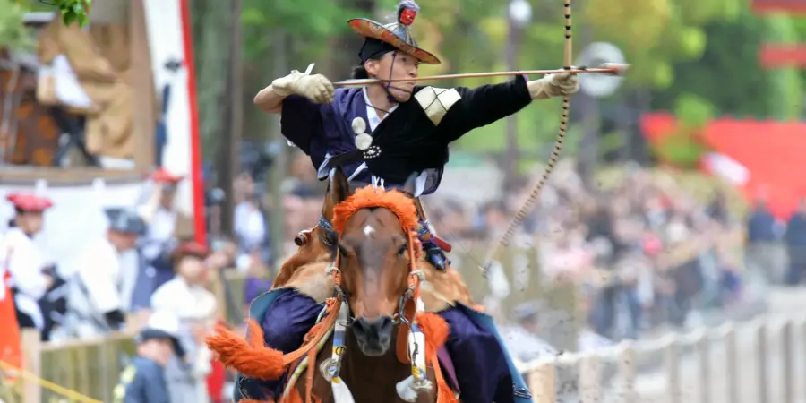 Man on horse back shooting an arrow, traditional style at the Kamakura Matsuri