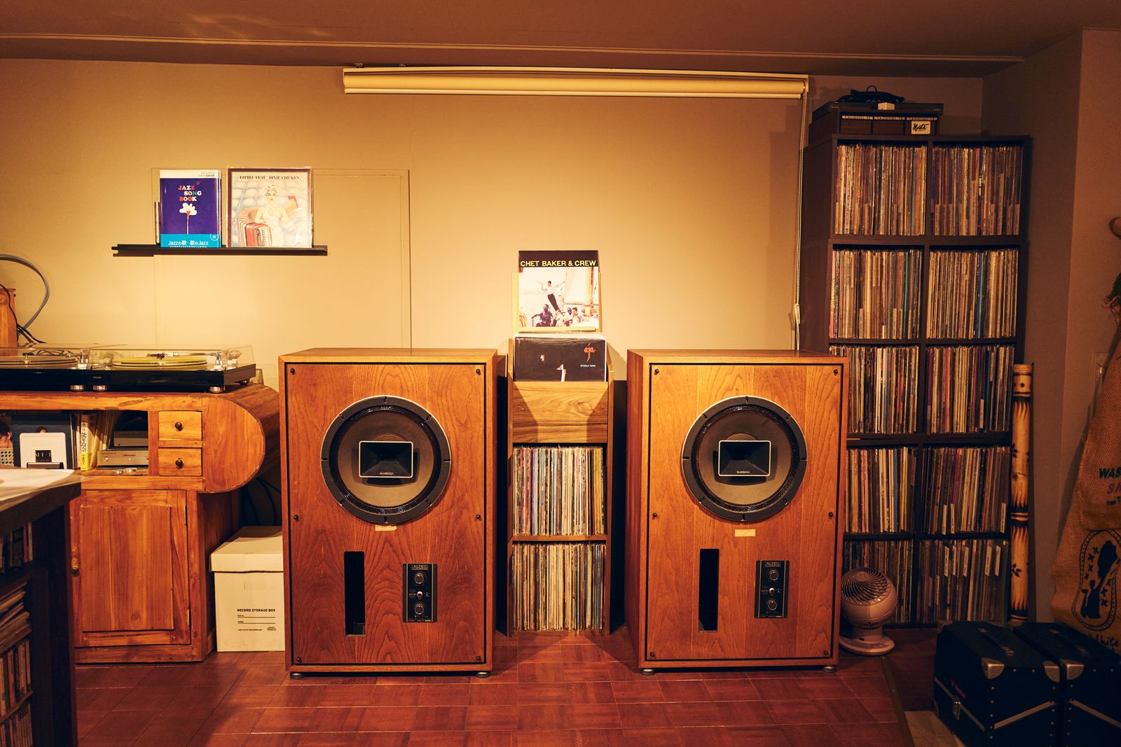 Image may contain Electronics Speaker Stereo Box Art Painting Wood Furniture and Person