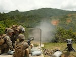 Marines of the 12th Marine Littoral Regiment practice with .50-caliber machine guns on a firing range on Okinawa.