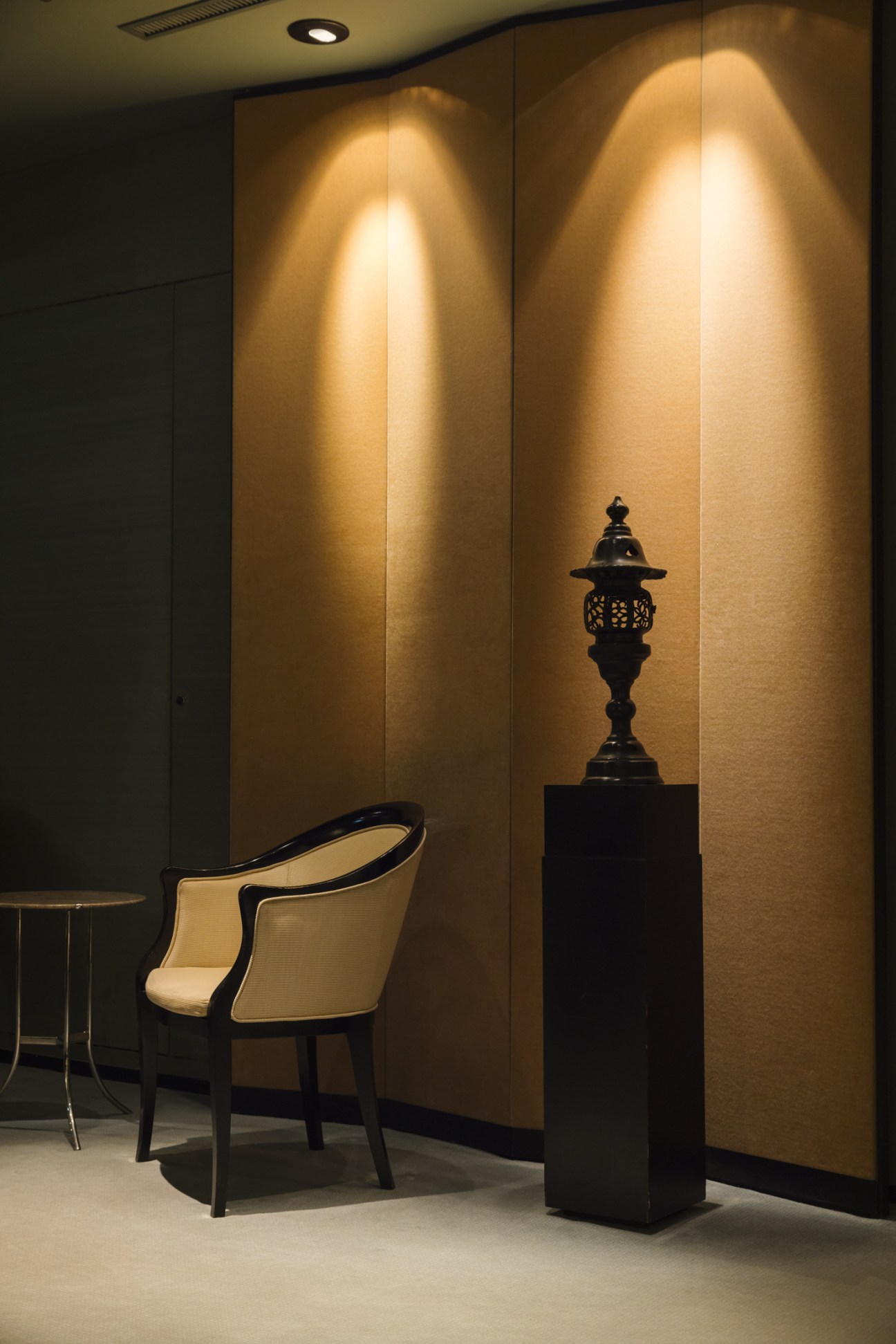 Textured woven wall coverings and atmospheric lighting in the reception