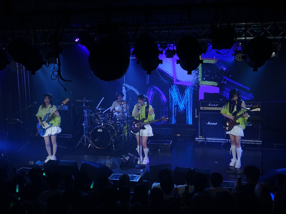 Rock band QWER perform during its first fan concert, “1, 2, QWER!,” in Osaka on April 10. [TAMAGO PRODUCTION]