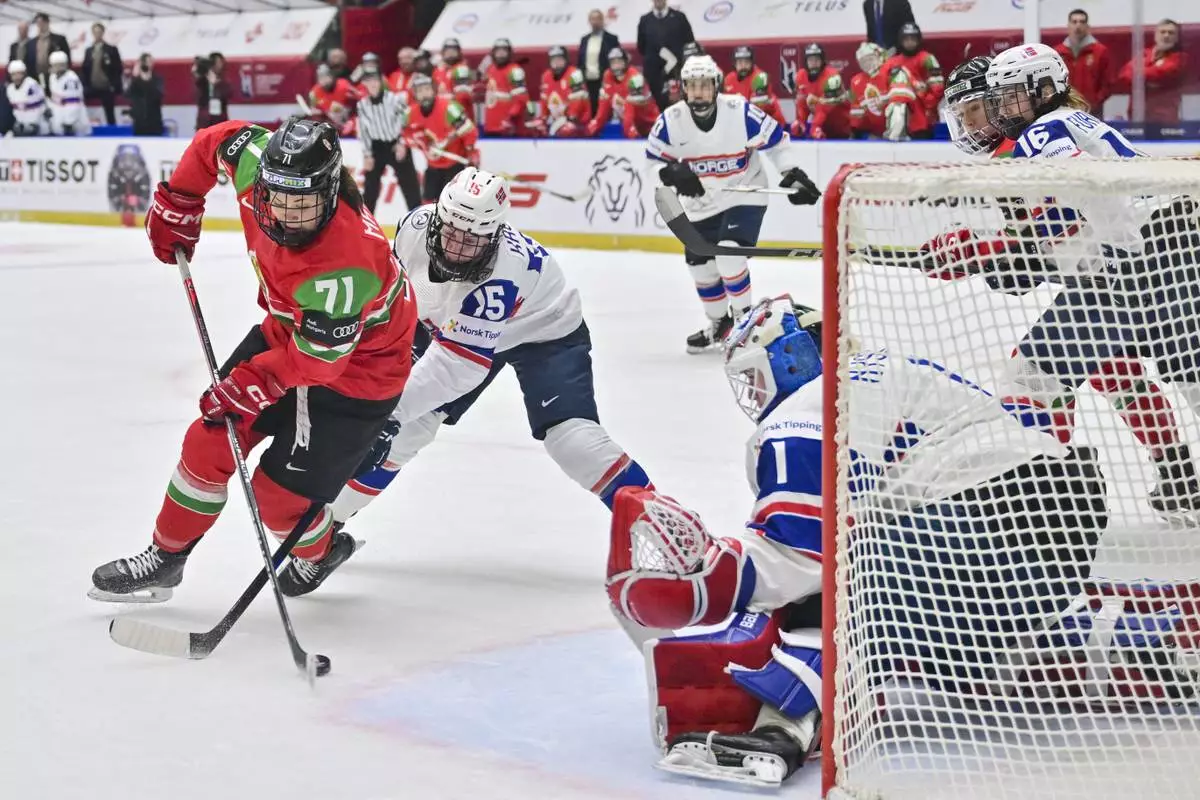 From left, Fruzsina Mayer of Hungary, Emilie Kruse of Norway and goalkeeper Ena Nyström of Norway in action during the IIHF Women's World Championship, Group B, match between Hungary and Norway, in Ceske Budejovice, Czech Republic, Sunday, April 13, 2025. (Václav Pancer/CTK via AP)