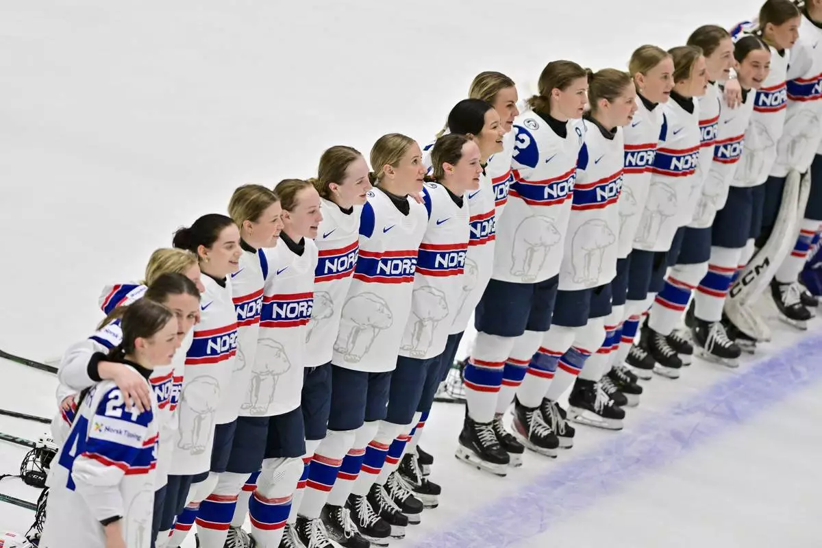Norway's players line up during the national anthem for the winners during the IIHF Women's World Championship, Group B, match between Hungary and Norway, in Ceske Budejovice, Czech Republic, Sunday, April 13, 2025. (Václav Pancer/CTK via AP)