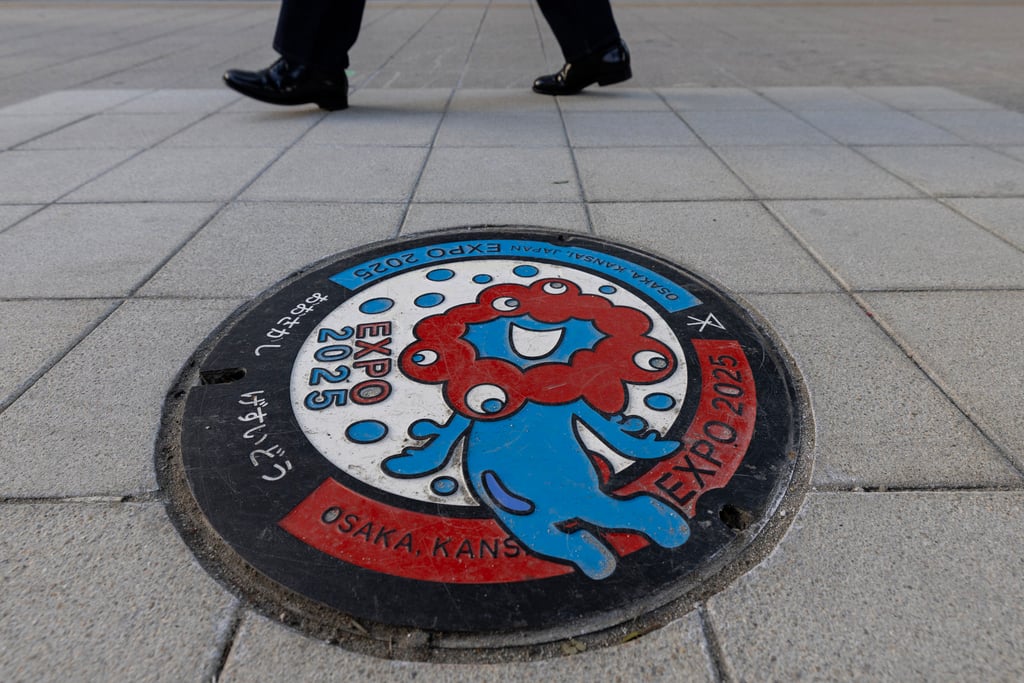 The Expo 2025 logo, designed to resemble a creature made up of connected red cells, expressing the brilliance of life, adorns manhole covers in Osaka, Japan. Photo: Getty Images