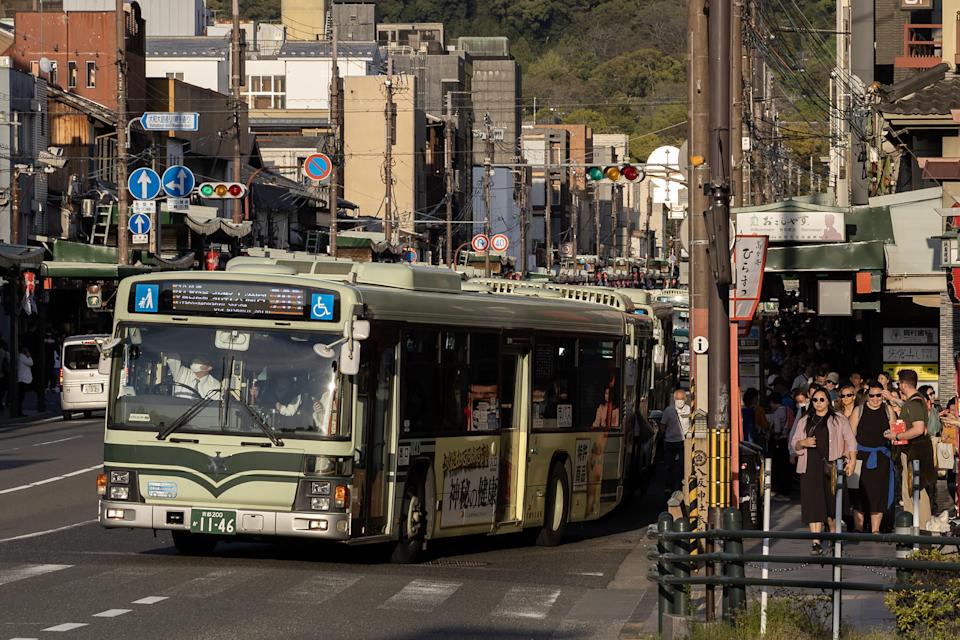 A city bus drives along a street in Kyoto, Japan, on Saturday, April 13, 2024.  / Credit: Buddhika Weerasinghe/Bloomberg via Getty Images