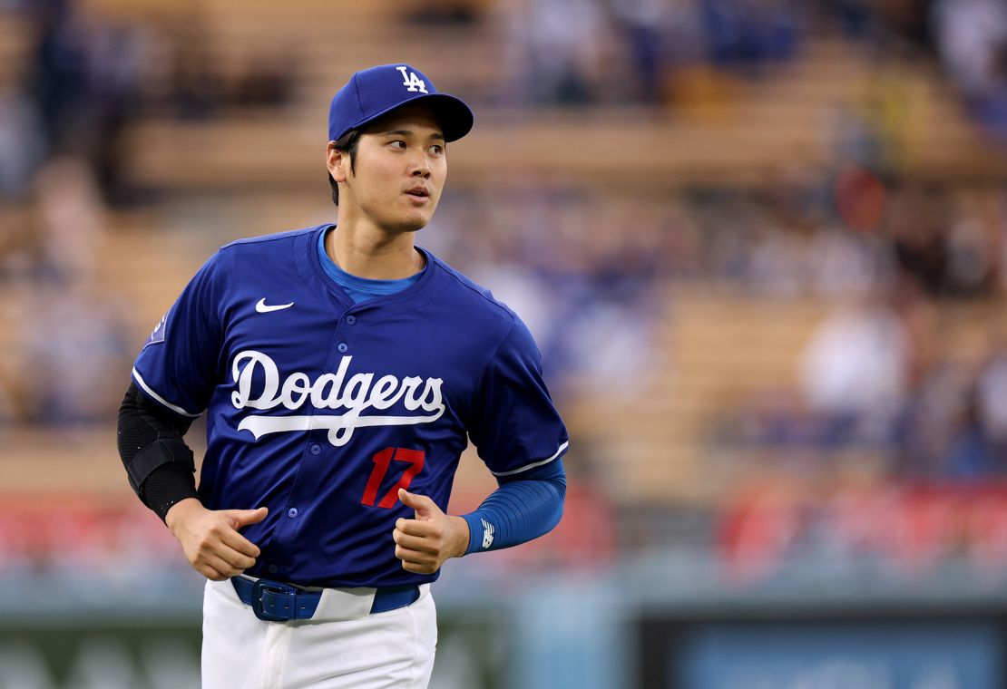 Shohei Ohtani warms up before a preseason game against the Los Angeles Angels at Dodger Stadium on March 24, 2024.