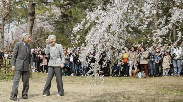 In this file photo from 2019, Japanese Emperor Akihito (L) and Empress Michiko were out to witness the weeping cherry in Kyoto Gyoen national garden in Kyoto. That year everything was imbued with an extra meaning. It was the last cherry blossom season of the Heisei imperial era that began with Akihito’s ascension in 1989. (Yosuke Mizuno / Kyodo News via AP)