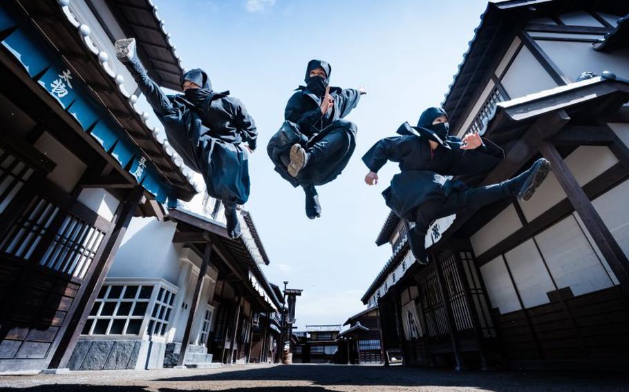 three ninja umping on the street.