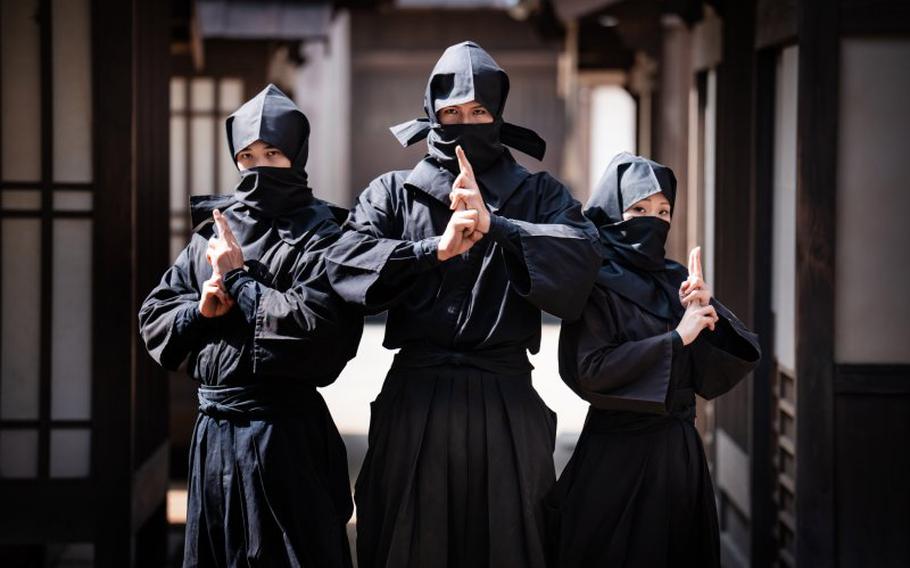 3 ninja pose for a photo.