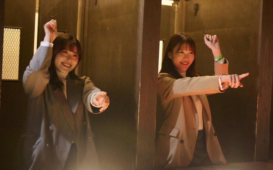 two women enjoying shuriken thorwing.