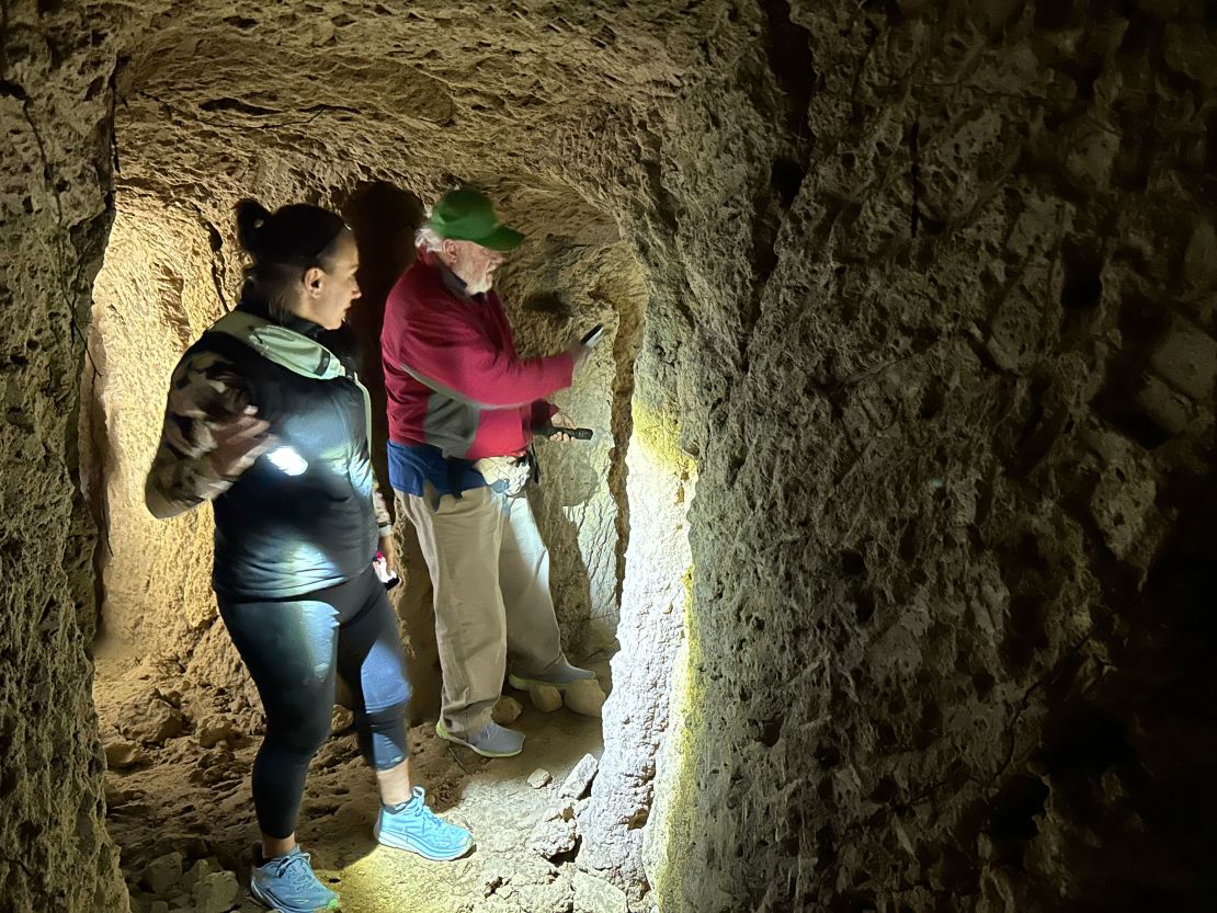 American Steph Pawelski and a fellow history enthusiast explore a World War II-era military cave on Okinawa.