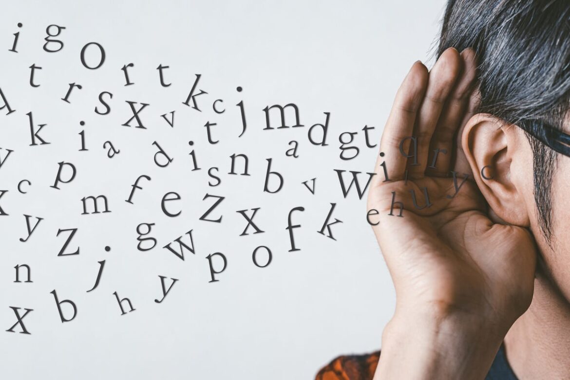 Survey: Japanese People Have No Confidence In Their English – But Tourists Say It’s Great Man holding his hand up to his ear while an unintelligible stream of Latin characters enters it