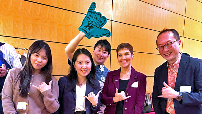 5 people waving Shaka