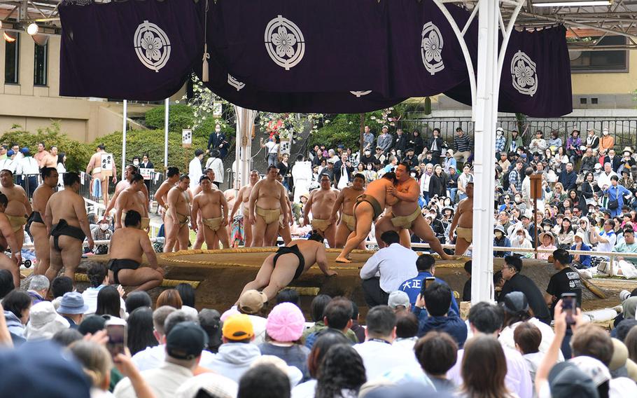 Sumo wrestlers warm up before ahead of their bouts at Yasukuni Shrine in Tokyo, April 14, 2025.