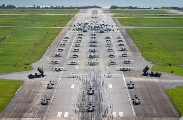 US Air Force, US Army, and US Navy assets line up on the runway for an