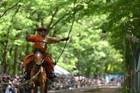 An archer shoots an arrow from horseback at Shimogamo Shrine in Kyoto's Sakyo Ward during the 