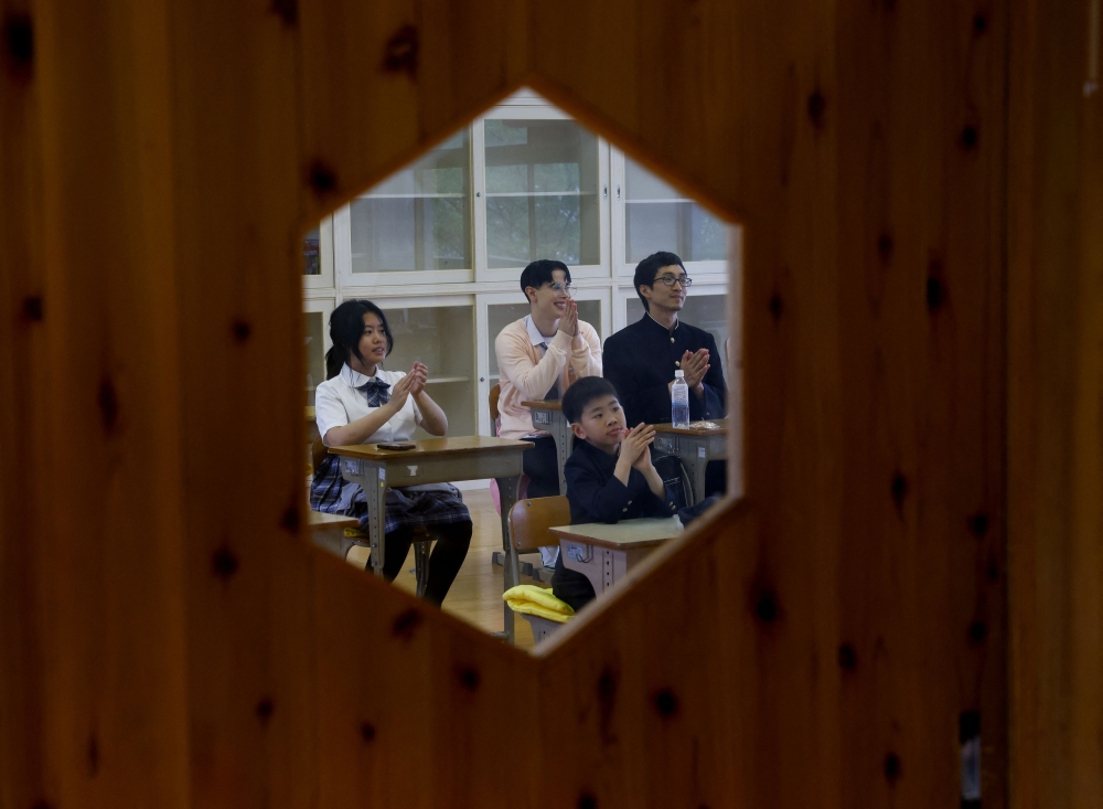Tourists from abroad take part in a Japanese high school experience in Kimitsu. — Reuters pic