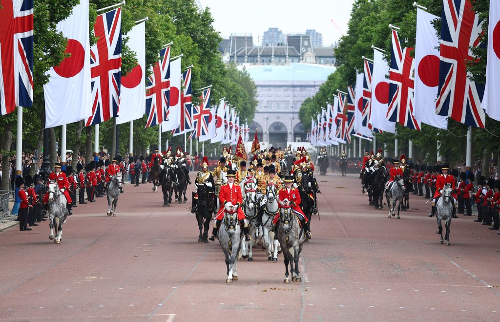 Royal carriages carrying King Charles, Queen Camilla, Emperor Naruhito and Empress Masako travel along The Mall during Japan state visit