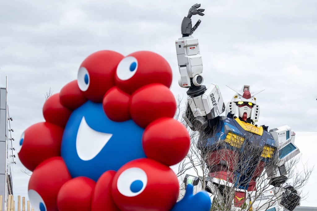 The “Myaku-Myaku”, the mascot of the 2025 Osaka Expo, and the Gundam pavilion seen on the first day of the expo on April 13. Photo: AFP